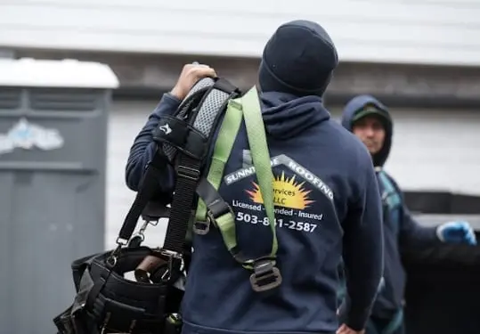 Sunnyside Roofing technician carrying safety harness