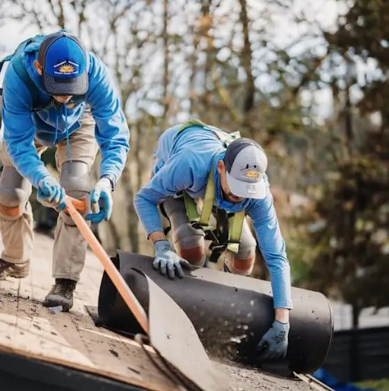 Sunnyside Roofing workers preparing underlayment during a residential roof replacement